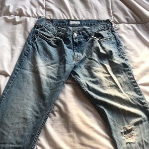 Destressed denim jeans